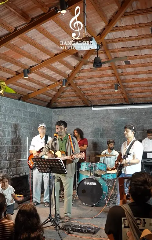 Musicians performing live at Aralikatte Cafe under the tiled roof